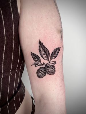 Detailed blackwork tattoo of fruit, berry, branch, and leaf by talented artist Robin Rossi.