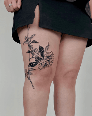 Blackwork tattoo of a detailed floral branch, featuring intricate botanical etching style by artist Alona Hamova.