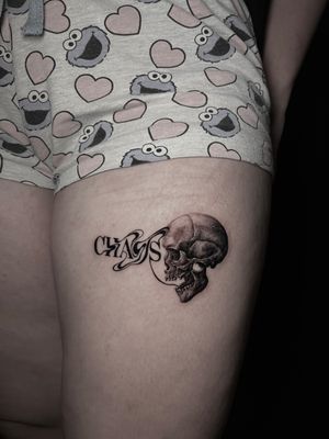 Stunning black and gray tattoo featuring a skull with glitch elements, skillfully done by artist Lauren.