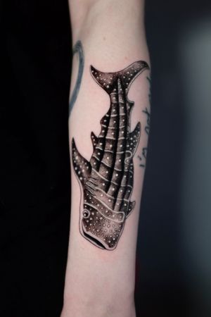 Embrace the beauty of the ocean with a stunning black and gray whale shark tattoo by Andrea. The intricate dotwork and micro realism bring this majestic sea creature to life.