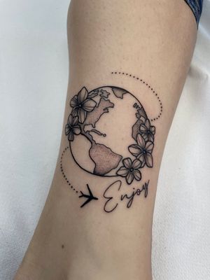 This black and gray dotwork tattoo by Marc 'Cappi' Caplen features a stunning floral globe, symbolizing wanderlust and love for the planet.