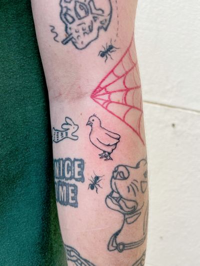 Detailed blackwork bird tattoo with delicate fine lines and dots, hand-poked by artist Laura.