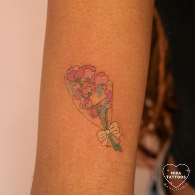 A fine line illustrative tattoo of a cute and colorful flower bouquet designed by Mika Tattoos.