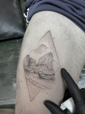 Fine line black and gray tattoo by Ali Bloom featuring serene clouds, mountain scenery, a boat on calm waters.