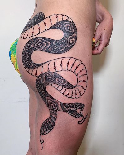 A mesmerizing blackwork snake tattoo, intricately crafted with dotwork details, located in New York.