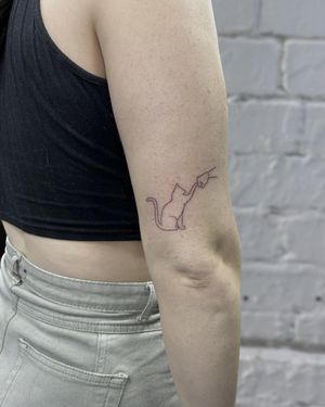 Elegant and detailed cat outline fistbump tattoo, expertly executed in fine line illustrative style by tattoo artist Ellie Shearer.