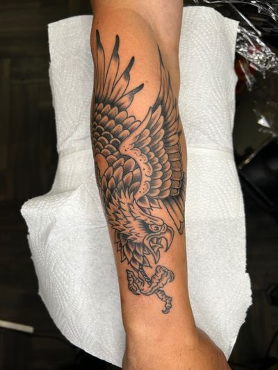 A black and gray traditional style tattoo of an eagle, designed by Barney Coles.