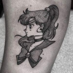 Get enchanted by this stunning anime tattoo featuring Sailor Moon and Sailor Jupiter, inked by Barbara Nobody.