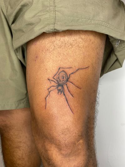 An illustrative black and gray tattoo of a spider, expertly crafted by Charlie Macarthur. The intricate design captures the mystery and beauty of these arachnids.