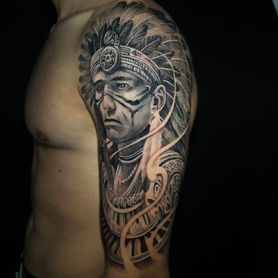 Experience the power of Native American culture with this stunning black and gray realism tattoo by Justin JP Param.