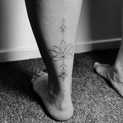 Detailed fine line lotus design by artist Inna, intricate and elegant.