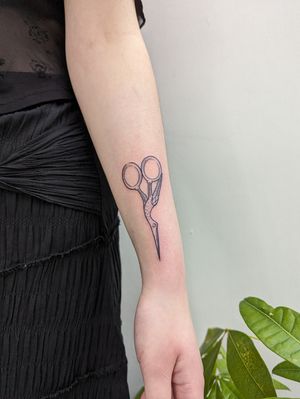 Detailed blackwork tattoo by Sara Jensen featuring a medieval scissor design with fine line etching technique.