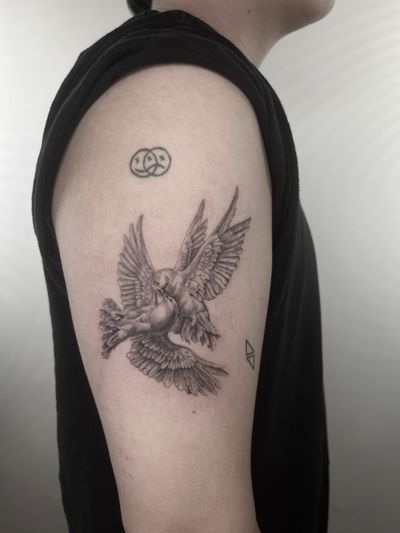 Detailed black and gray tattoo of a bird, designed by Lauren. Realistic style with micro details.