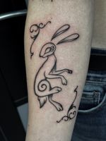 A rabbit with ornamental corners around it. Taken from a fantasy story with a swirl in the middle.