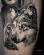 Healed Wolf Portrait – Black & Grey Realism Tattoo Black and grey realism tattoo of a wolf, symbolizing loyalty, instinct, and resilience. Detailed texture and soft shading create depth and expression. Tattooed by London artist Roudolf Dimov, known for lifelike animal realism and symbolic compositions.