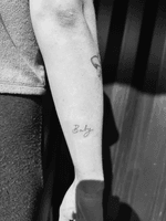 Fineline script ‘baby’ tattoo