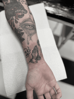 Beautiful black and gray illustrative tattoo of praying hands by Dani Mawby. Capturing the essence of faith and devotion.