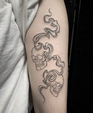 Abstract fine line tattoo of a skull, intricate and unique, by artist Amandine Canata.