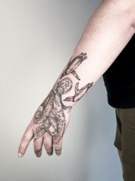 Octopus and Penguin Hand Tattoo