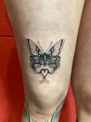 Unique blackwork fine line tattoo by Robert Buckley-Warner, combining butterfly, heart, and glitch motifs.