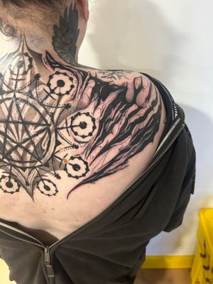Unique dotwork tattoo by Lawrence Canham, featuring a rune design with scratch details and pentagram accents.