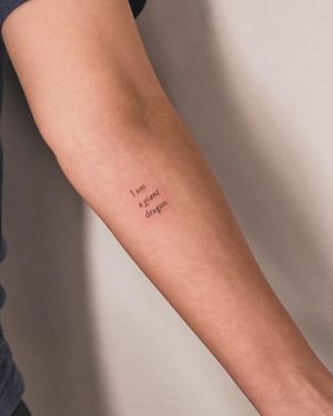 Get inked by Alex Caldeira with a delicate small lettering tattoo design that speaks volumes in style.