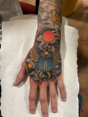 Vibrant sun and mystical scarab beetle design with smoky touch up by Lawrence Canham. Explore the ancient symbolism through neo-traditional art.