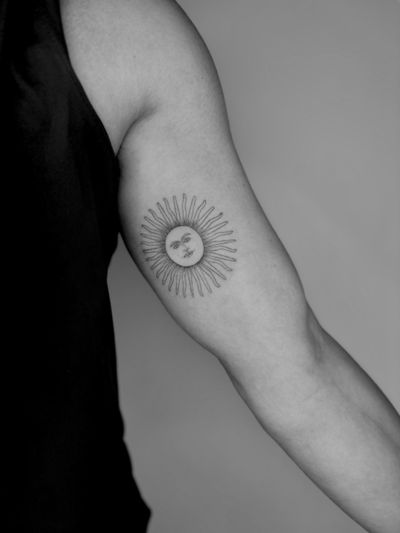 Fine line ornamental tattoo of a sun motif created by artist Ruth Hall.