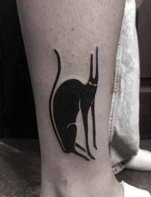 Experience the elegance of le chat noir in this stunning blackwork tattoo by Amandine Canata.