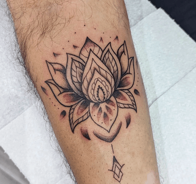 Get a stunning ornamental lotus tattoo by GROWN TATTOOS for a timeless and intricate piece of body art.