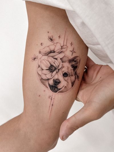 Illustrative tattoo by Alex Caldeira featuring a pet dog surrounded by delicate flowers in black and gray fine line style.