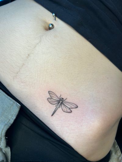 Get inked with a stunning illustrative dragonfly tattoo by Jonathan Glick. Embrace the beauty and symbolism of this majestic creature.