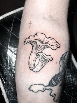 Fine line illustrative tattoo by Alexandra Mulhall featuring a detailed woodcut design of a medieval mushroom.