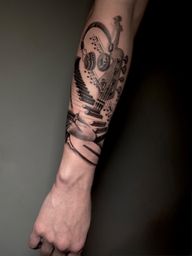 Black and grey music tattoo featuring instruments, headphones and musical notes. A tribute to passion, creativity and the universal language of music.