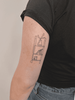 A fine line tattoo of a singleline bookshelf, created by Alexey. Simple and elegant design.