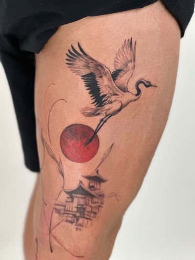 Capture the beauty of nature with this black and gray fine line tattoo featuring a majestic crane against a stunning sunset backdrop. By Saka Tattoo.