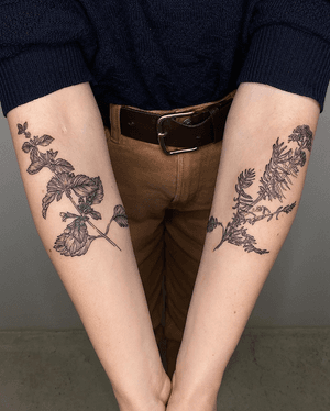 A delicate blackwork etching tattoo featuring intricate botanical designs by artist Alona Hamova.