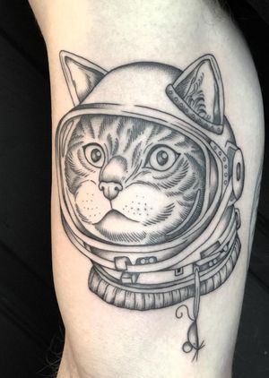 Unique illustrative tattoo featuring an astronaut cat in a woodcut style, by Amandine Canata.