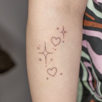 Elegant and detailed fine line design combining stars and hearts, expertly crafted by Mika Tattoos in an ornamental and illustrative style.