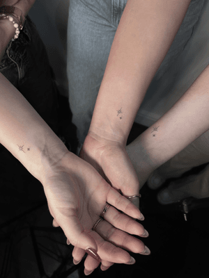 Matching fine line star tattoo