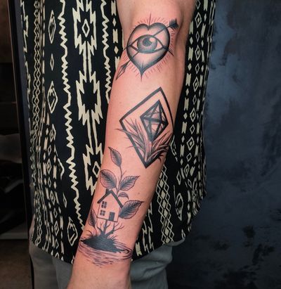 A unique black and gray tattoo by Kateryna Goshchanska featuring a heart made of patchwork design, with an eye, polygon, and house elements incorporated.