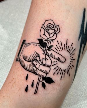 Experience Andrew Garinther's blackwork masterpiece featuring a beautifully detailed rose design on hand, inspired by woodcut art.