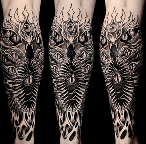 Experience the horror with this chilling blackwork tattoo featuring a demonic creature's eye. Expertly done by Ker Kusterbeck.