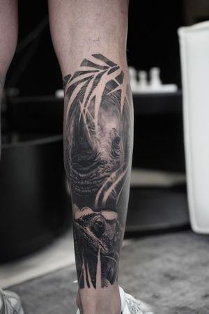 Capture the essence of African safari with this stunning black and gray rhinoceros tattoo by Nicholas Dimpsey.