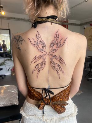 Captivating tribal design featuring mystical wings and fairy motif by artist Beth Farbrother.