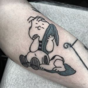 Capture the nostalgia with this illustrative tattoo featuring Snoopy, Linus, and Charlie Brown. By Barbara Nobody.