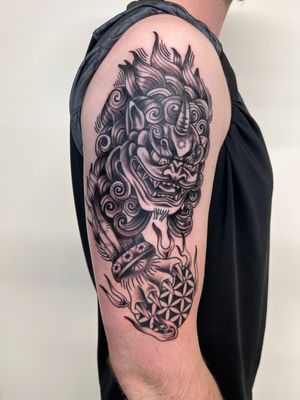 Black and gray traditional style tattoo of a Japanese Foo Dog, done by Kayleigh Cole.