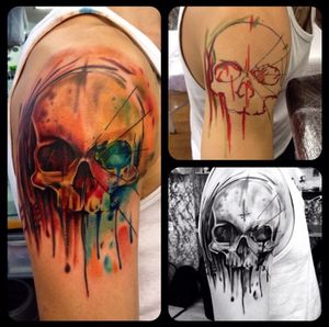 Vibrant watercolor skull tattoo on upper arm by Sandro Secchin, featuring a modern twist on traditional new school style.