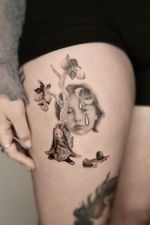 A poetic surreal realism tattoo in black and grey micro realism, featuring a lemon tree, a wrapped doll figure and a blurred crying face with halved lemons as eyes. A melancholic dreamlike composition exploring emotional fragmentation.