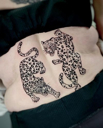 Get a fierce and detailed blackwork tattoo featuring a stunning leopard and jaguar design by the talented artist Andrea.